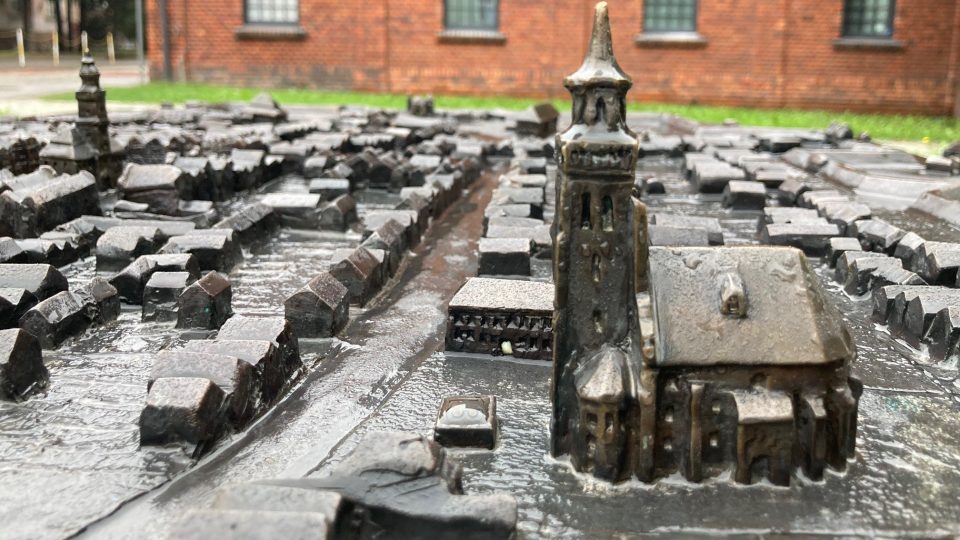 Model města z bronzu u bývalé městské brány s kostelem sv. Jana